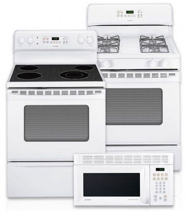White kitchen appliances including two stove-oven units, one with a smooth cooktop and one gas, and a microwave.